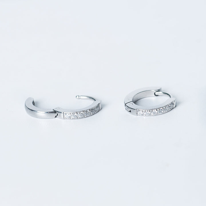 Silver Kyonne hoop earrings with clear diamonds shown in an open view on a white background