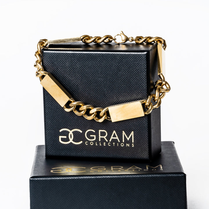 A close up view of large bar bracelet standing in the center of the image against a white background. 