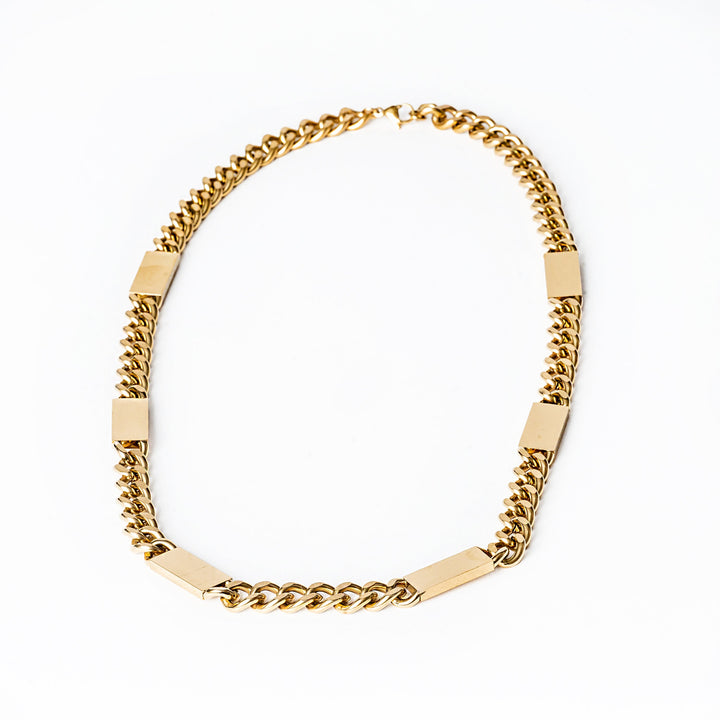 A bird view of Large Bar Necklace in Maltese style standing in the center of the image against a white background. 