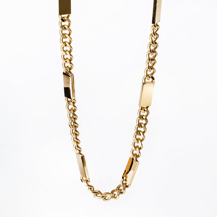 A close up view of Bar necklace chain, standing in the center of the image against a white background. 