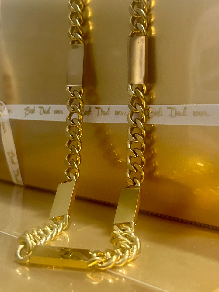 Gram collections large bar necklace standin in the center of the image. 