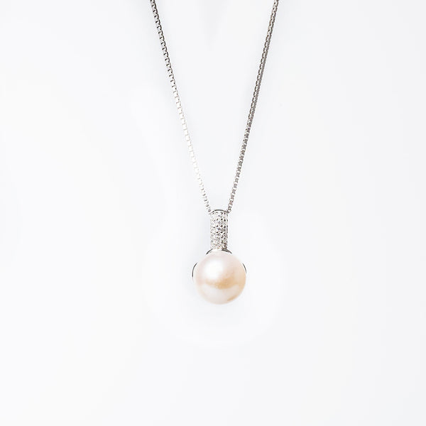 A silver Layla necklace featuring a single pearl charmer with a chain included, displayed against a white background.