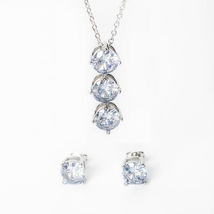 Silver Leia jewelry set featuring a necklace with three clear gemstones and matching stud earrings.