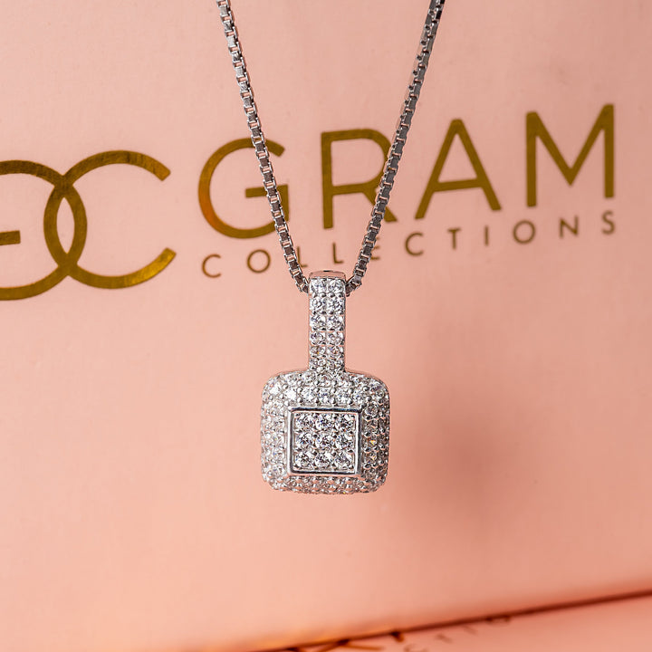 Liana necklace standing in the center of the image against its pink box in the background 
