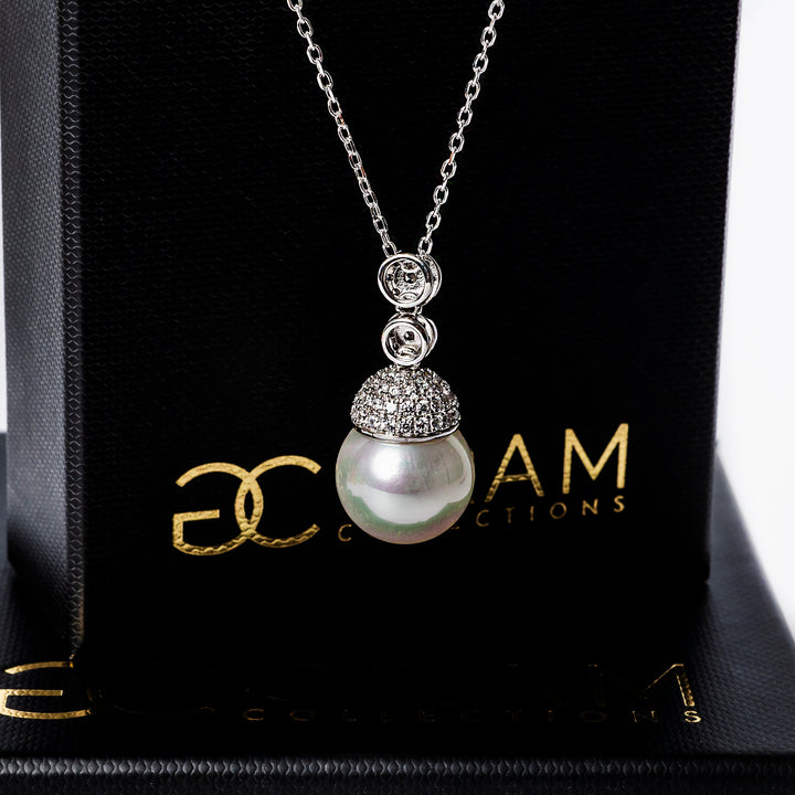 Lieni necklace standing in the center of the image against its black box. 