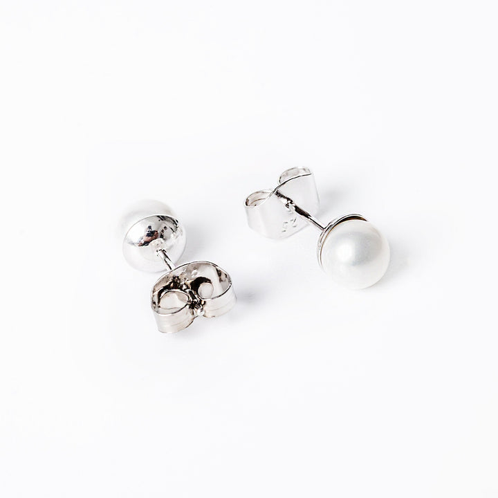 Lilly earrings standing against a white background. 