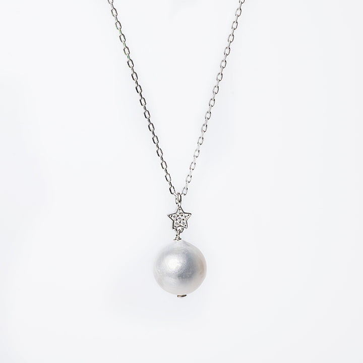 A silver Lina necklace with a single cultured pearl or cubic zirconia pendant, depending on the lighting, on a white background.