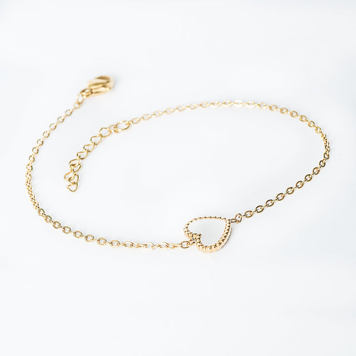 Lisa gold bracelet with a small open heart pendant on a fine chain