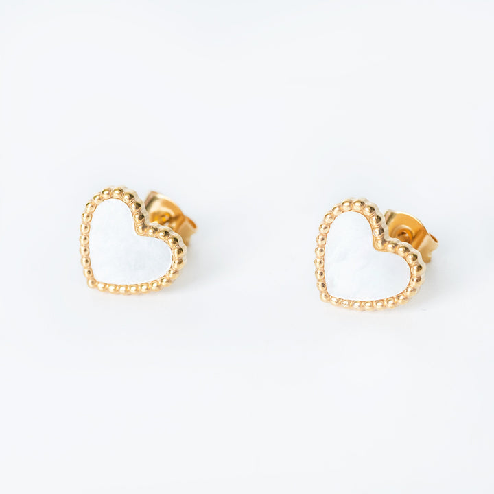 Lisa gold stud earrings with open heart design shown from a side angle