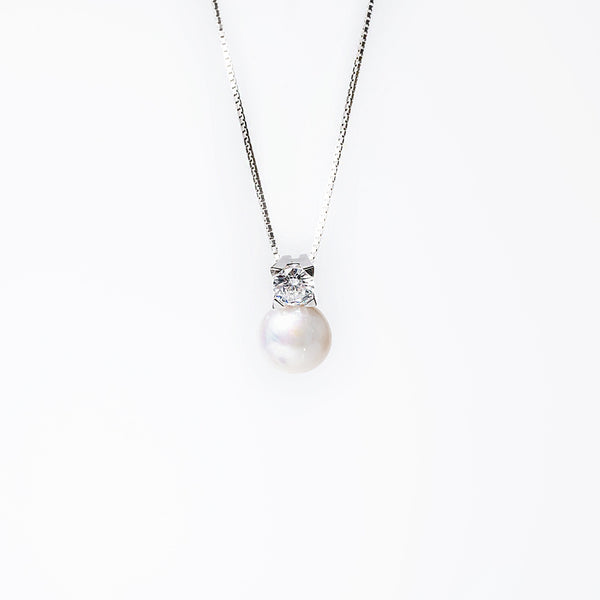 The close up view of logan necklace standing against a white background. 