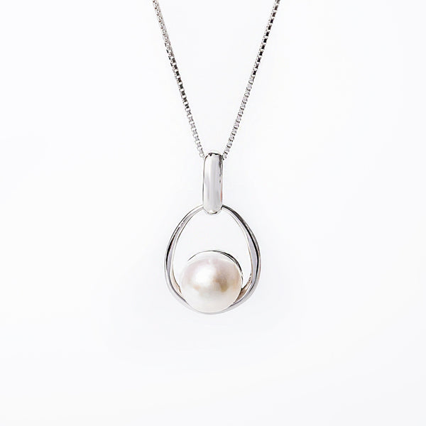 A silver Lola necklace featuring a single pearl and a small cubic zirconia gemstone, with a chain included.