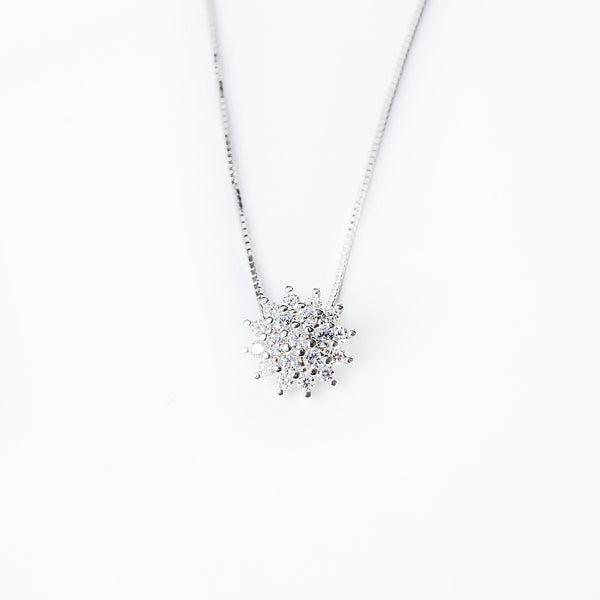 A sterling silver Lone necklace with a pendant featuring a cluster of cubic zirconia stones, displayed against a white background.
