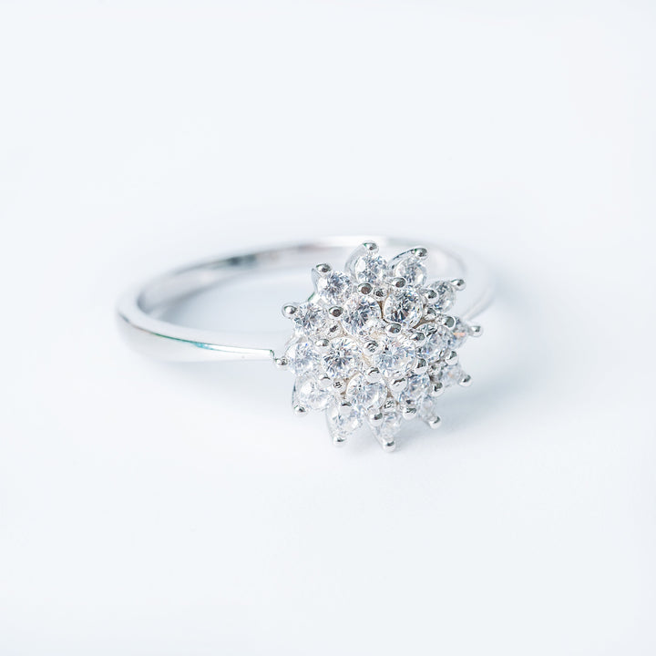 A profiel view of lone ring standing in the center of the image against a white background. 
