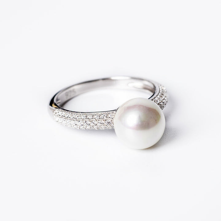 A close up view of Lorena Ring standing against a white background. 