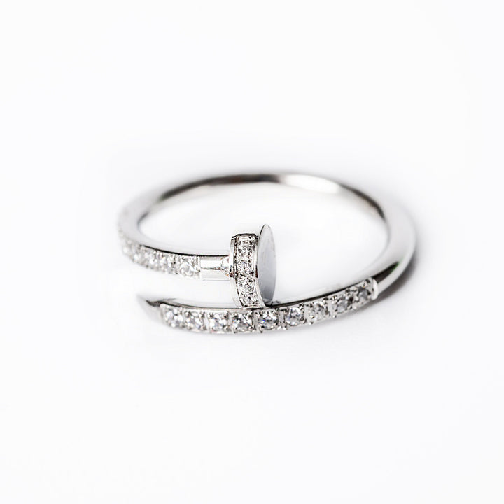 A silver ring featuring a band with small AAA cubic zirconia stones set around its circumference.
