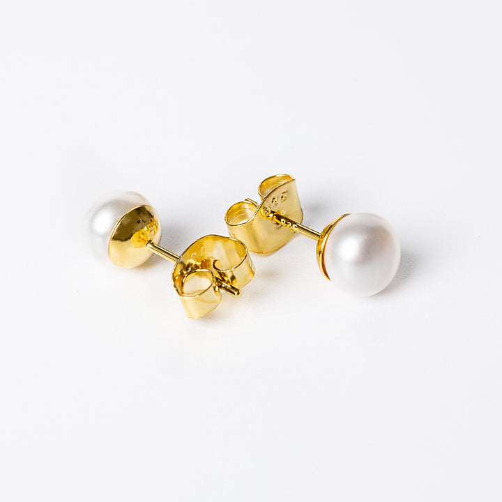 A close up view of Louana earrings standing against a white background. 
