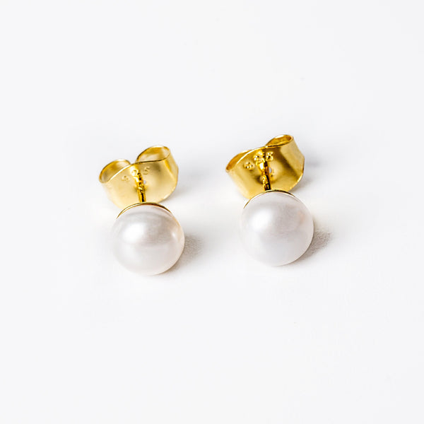 A pair of sterling silver  Louana earrings with yellow gold plating and adorned with cultured pearls.