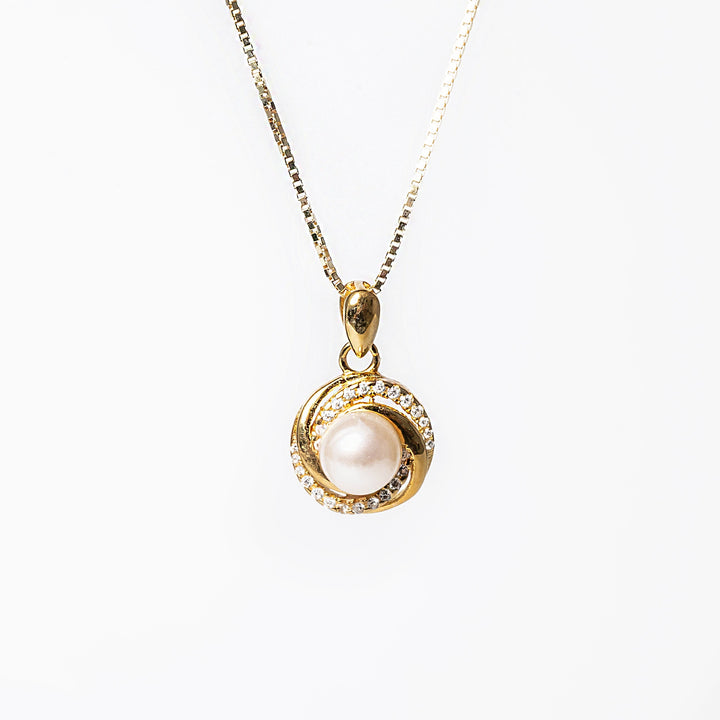 a silver Louanne Necklace featuring a gold-tone chain and a round pendant with a cubic zirconia and pearl design.