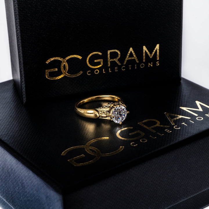Gram collections Louise Gold Ring placed on its box. 