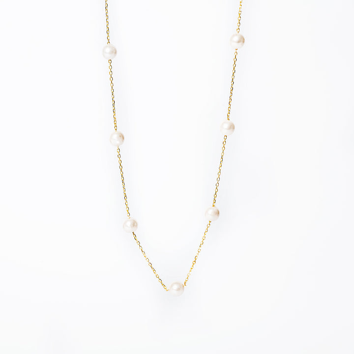 Lucille Necklace standing in the center of the image against a silver background. 