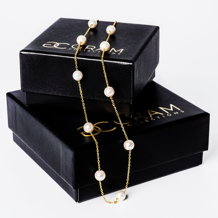 Lucille Necklace placed on its two boxes, standing on top of each other. 