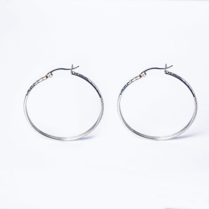 A profile view of Lucy SIlver Earrings standing next to each other. 