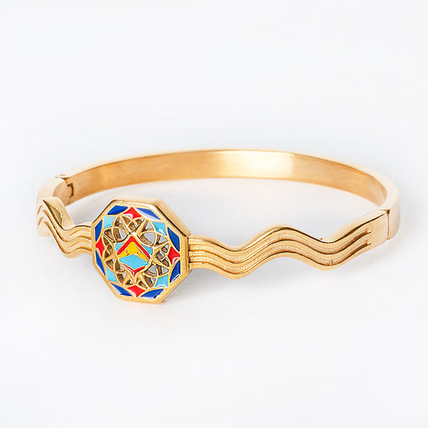 Gold Luzzu bracelet with a colorful hexagonal design on a white background