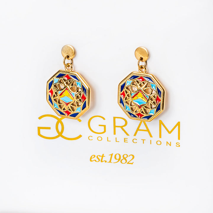 Gold Luzu earrings with colorful design on a white box, featuring the 'GRAM Collections' logo.