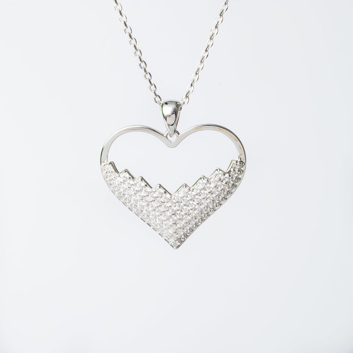 Lyn.necklace with a heart-shaped pendant featuring a cubic zirconia gemstone.