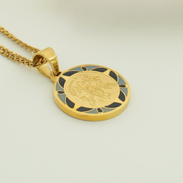 Madonna Ta Pinu Necklace pendant featuring a depiction of the Virgin Mary with a blue border, suspended on a matching gold-colored chain.
