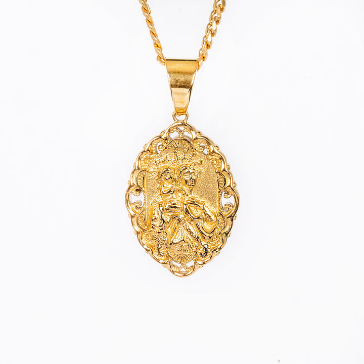 Madonna tal Grazzja necklace seeing from  front part, attached to a chain, standing in the center of the image, against a white background. 