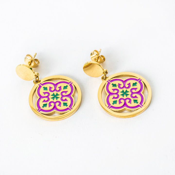 Maduma gold colour earrings with purple and green floral designs on a white background