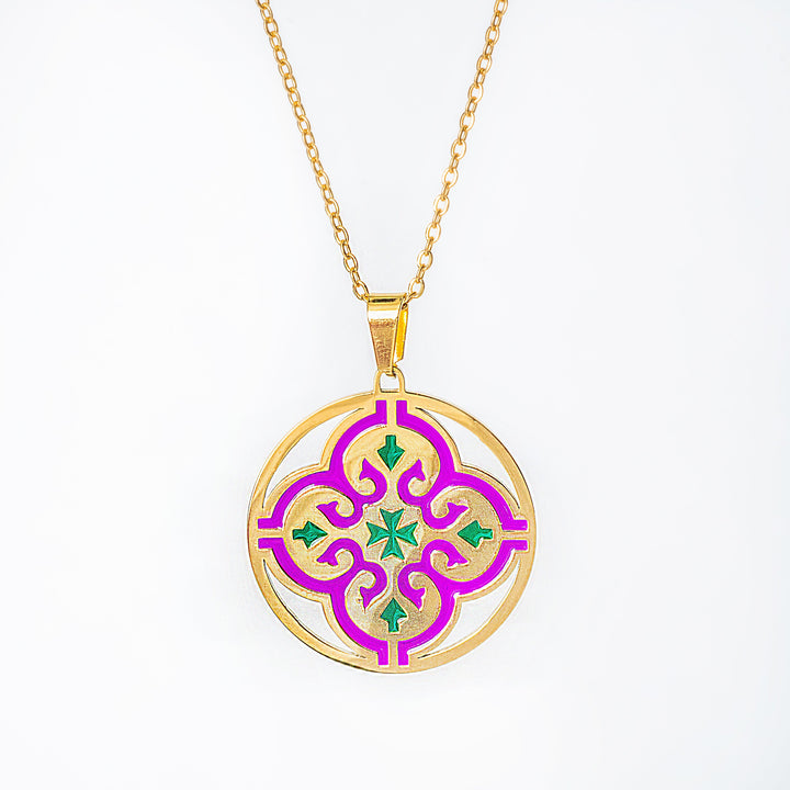 maduma necklace with a circular pendant featuring pink and green designs on a white background