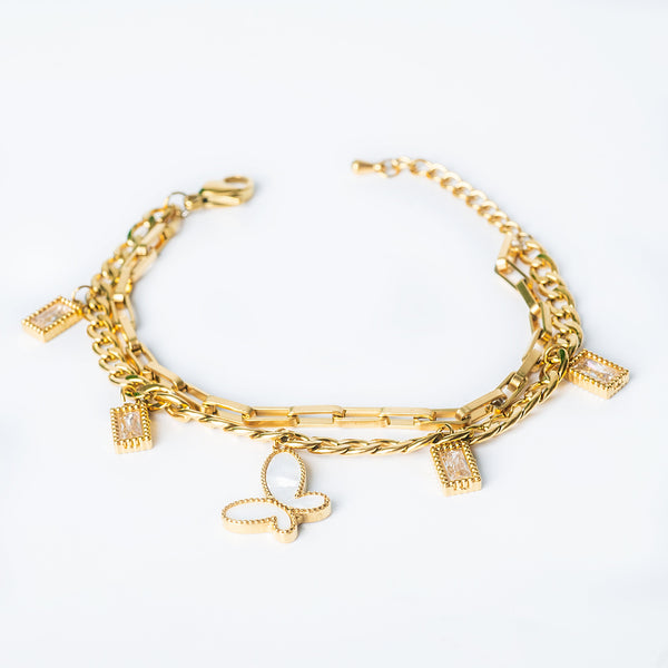 Gold Malayka bracelet with butterfly and crystal charms displayed on a white background