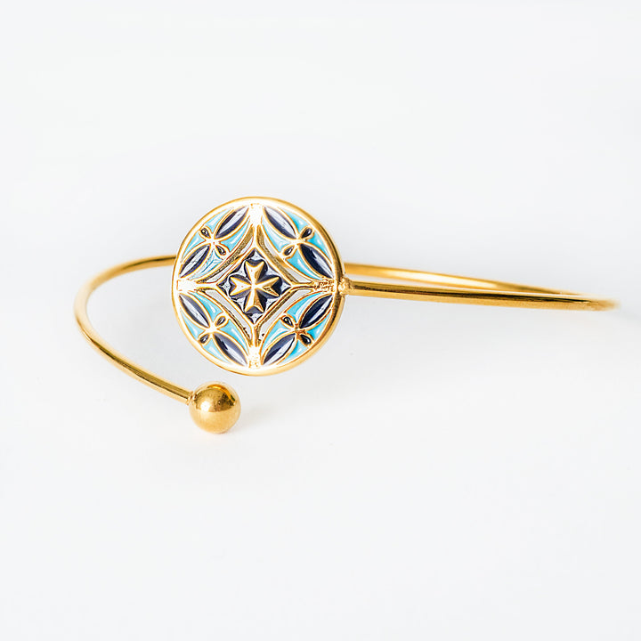 Gold Malta bracelet with intricate design on a white background