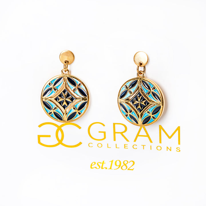 Gold and blue Malta earrings attached to its uniquely designed box with a 'GRAM COLLECTIONS' logo. 