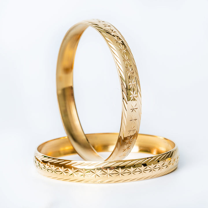 Malta's fili earrings standing in the center of the image against a white background. 