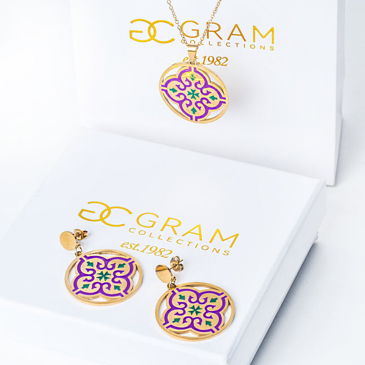 A close up view of Maltese cross Tiles Necklace placed on its box. 