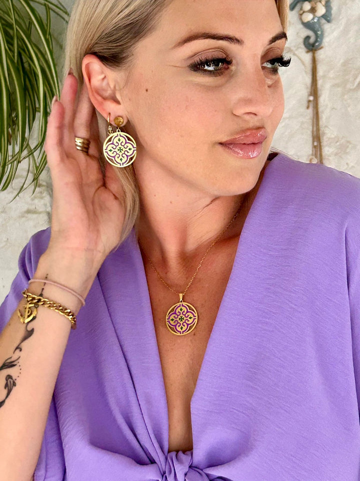 A close up view of Maltese cross Tiles Necklace on a model. 