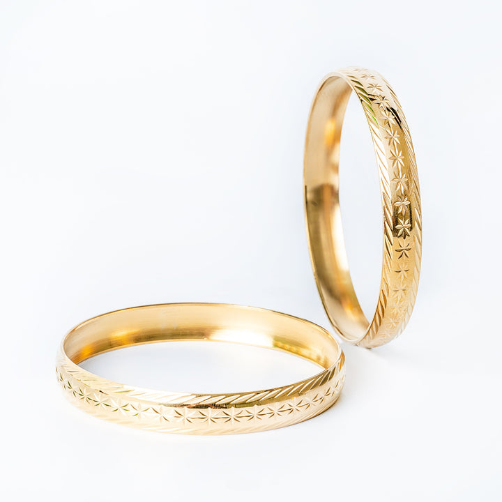 Side and profile view of Maltese Fili earrings standing in the center of the image against a white background. 