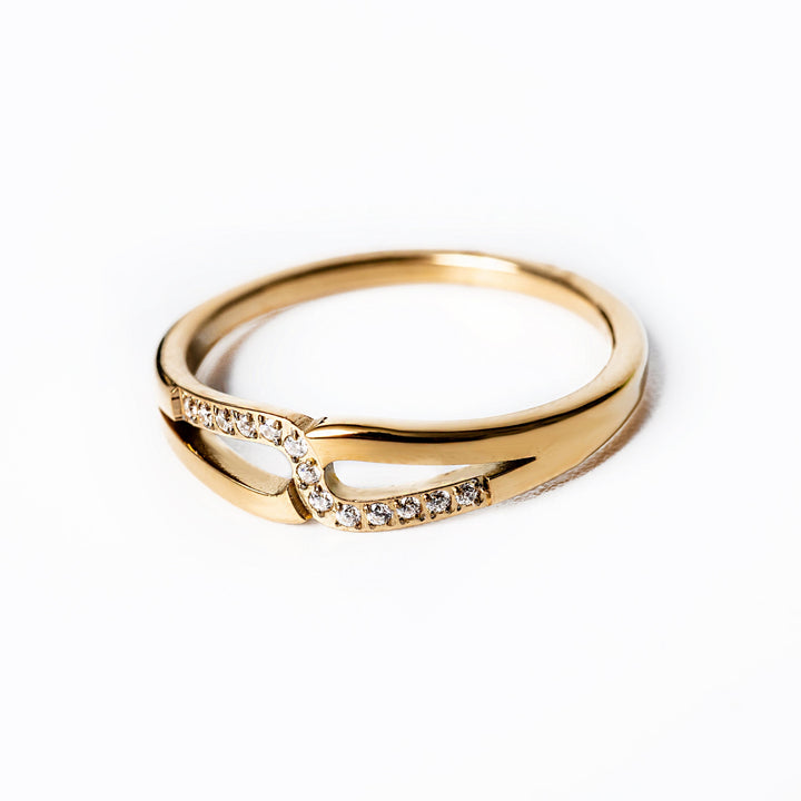 A close up view of Marianne Gold Ring standing in the center of the image against a white background.
