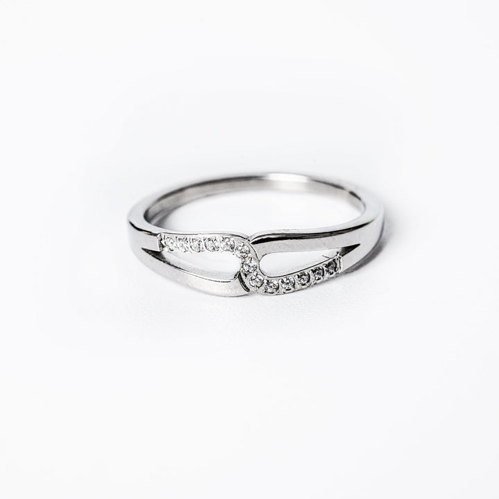 A silver-colored  Marianne ring with gold plating and adorned with cubic zirconia gems.