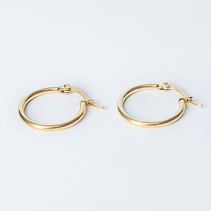 Gold Marion hoop earrings displayed on a white background
