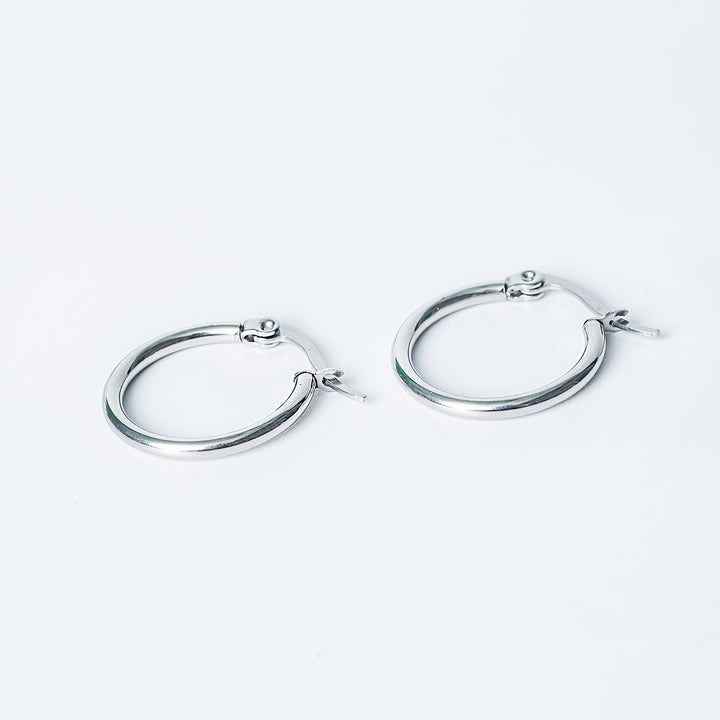 Silver Marion hoop earrings with smooth rounded finish displayed on a white background