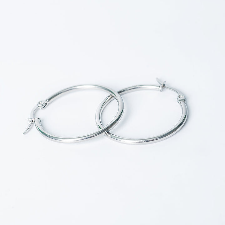 Silver Marlene hoop earrings with a smooth polished finish on a white background
