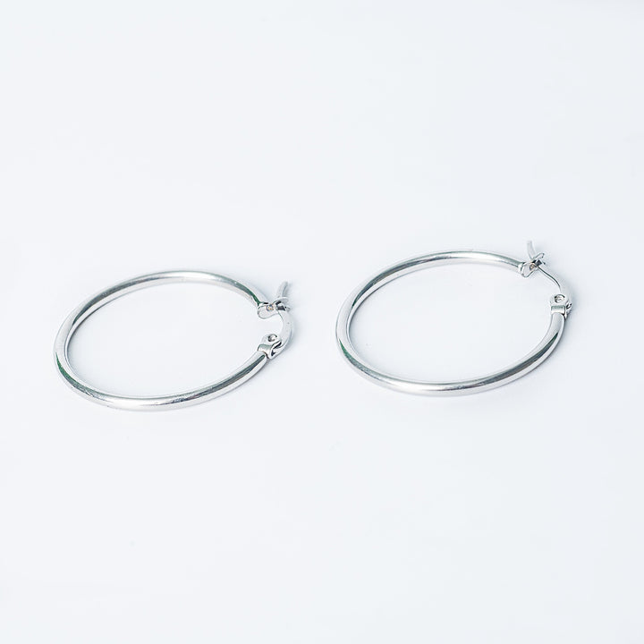 Silver Marlene hoop earrings with a smooth polished finish on a white background