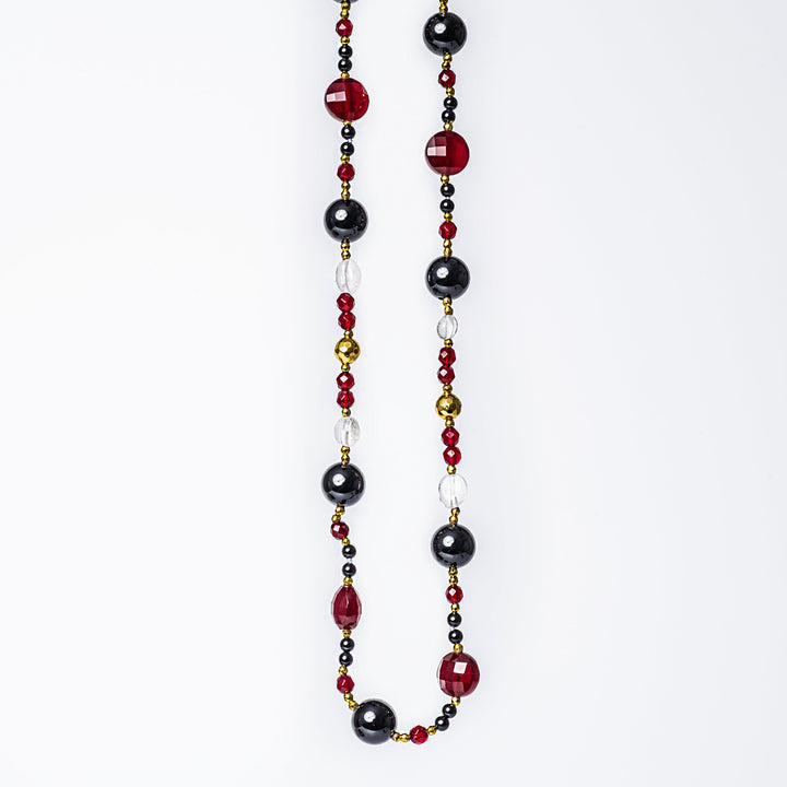 A close up view of a necklace standing in the center of the image 