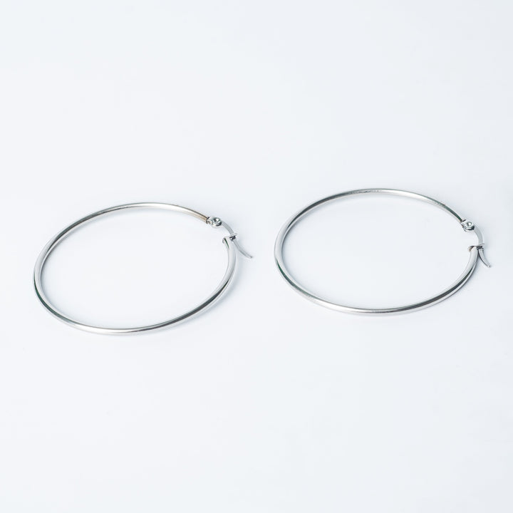 Silver Marthese hoop earrings displayed on a white background