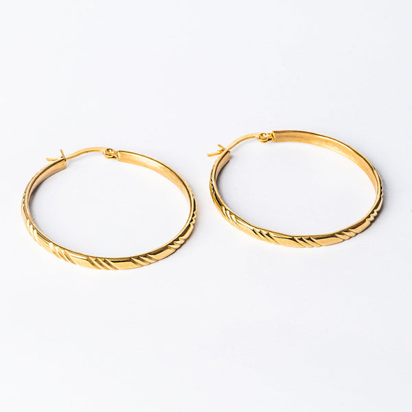 A close up view Maya Earrings standing in the center of the image against a white background. 