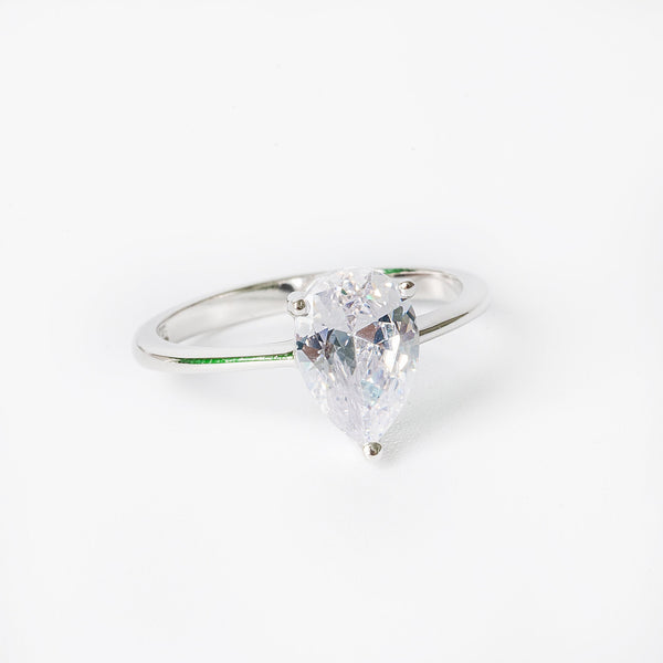 Melissa ring featuring a single cubic zirconia gemstone surrounded by smaller clear crystals, set in a hypoallergenic band.